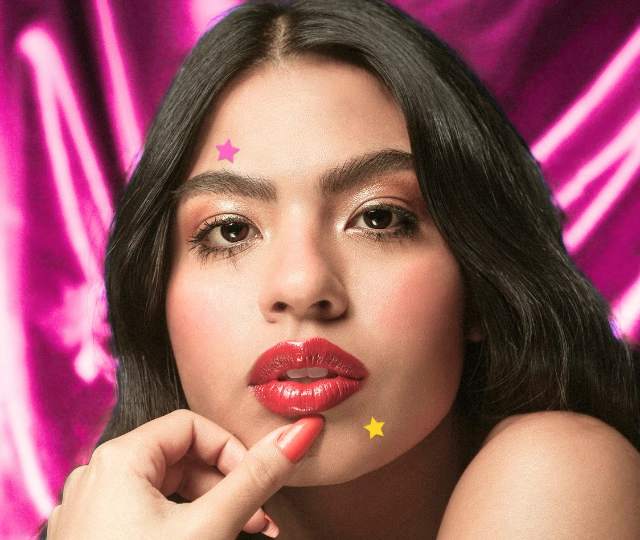 Closeup of a woman with two star shaped hydrocolloid pimple patches on her face for acne to test do pimple patches actually work